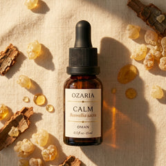 OZARIA CALM Royal Hojari Frankincense essential oil — luxury aromatherapy bottle on cream linen