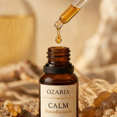 CALM Royal Hojari frankincense oil dropper close-up — single amber drop